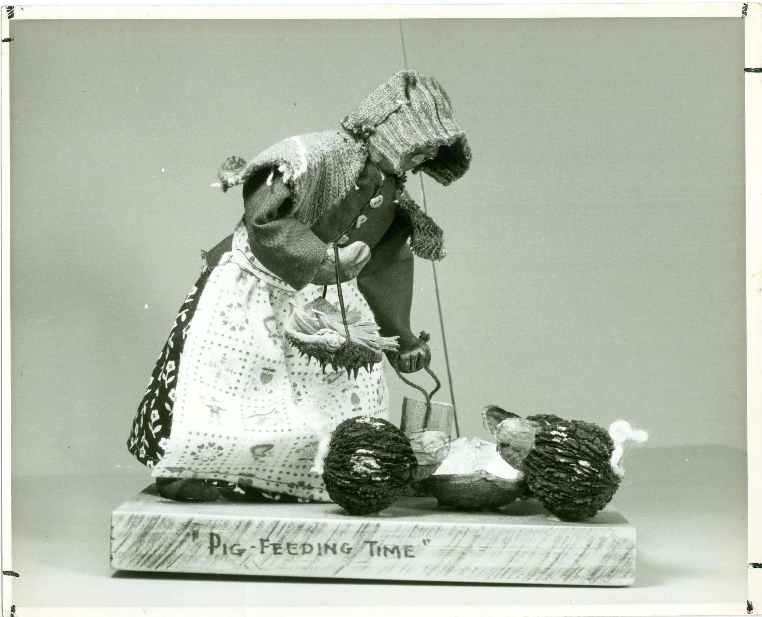  This Olive Cardwell figurine, called “Pigfeeding Time,” is made from walnuts, fabric, wood pieces, and acorns, among other natural materials 