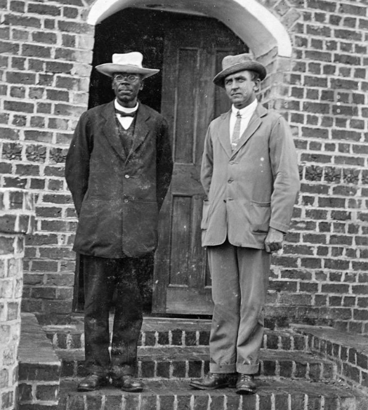  John Chilembwe and John Chorley , standing outside Chilembwe’s church in Mbombwe village in southern Malawi, Africa, 1914. Courtesy of Library of Congress ( https://www.loc.gov/item/93505648/ ) 